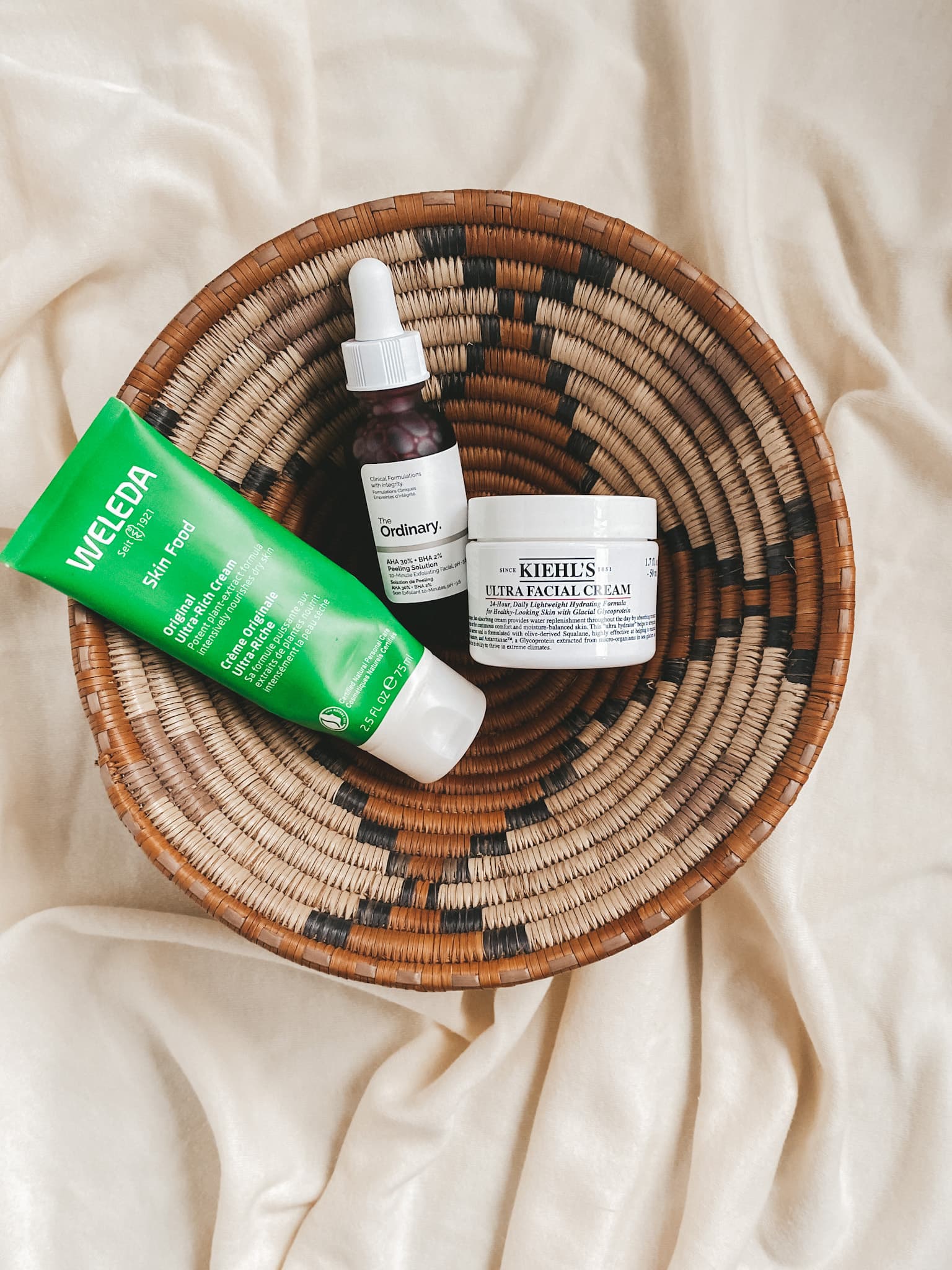 brown woven basket with welda skin food, the ordinary peeling solution and kiehl's ultra facial cream