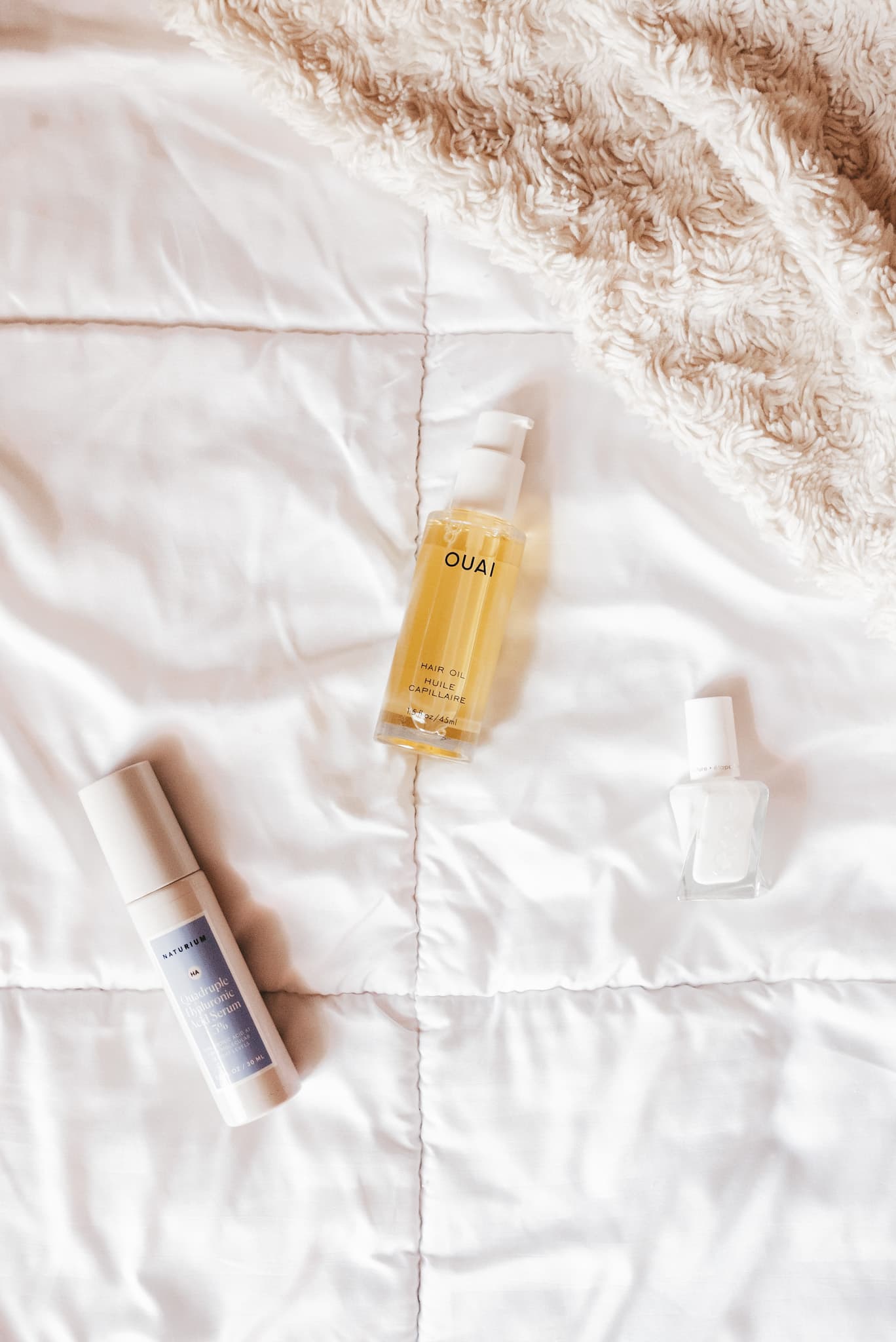 a white comforter with beauty products on it