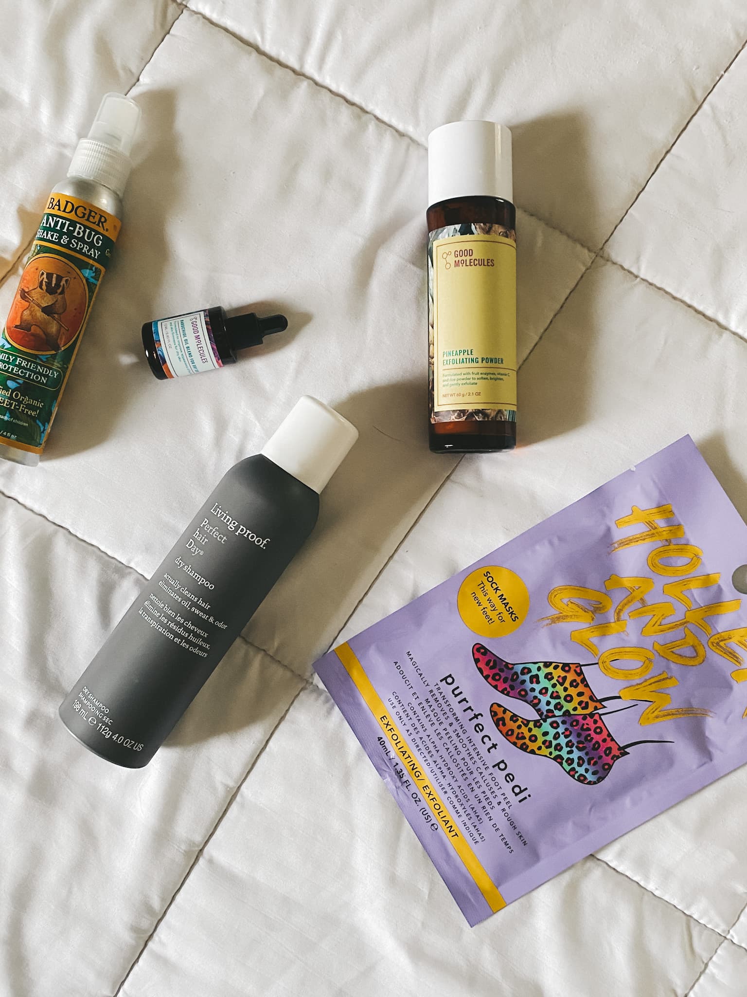 a white blanket with several beauty and skincare products