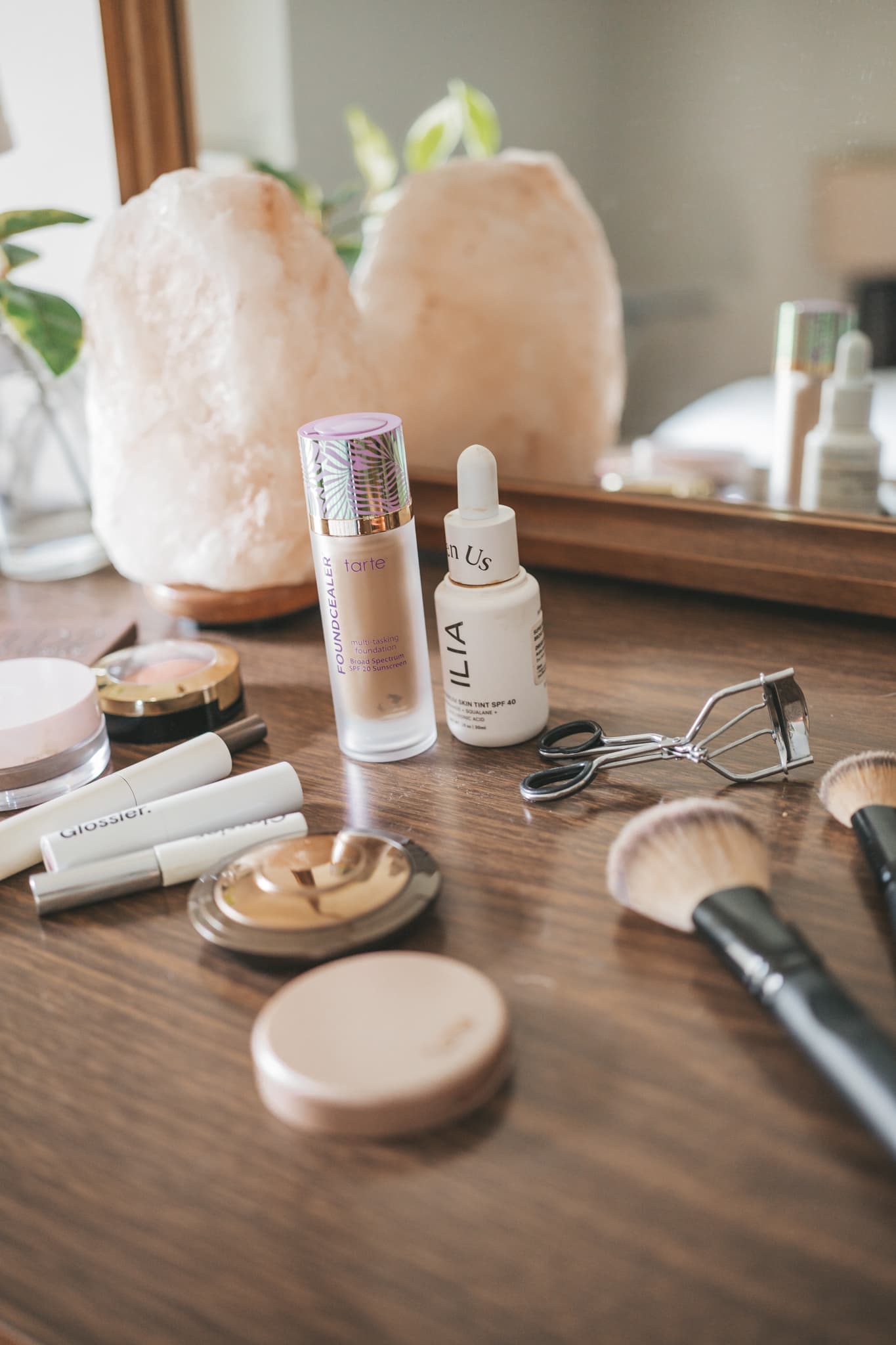 make-up laid out on a wood dresser