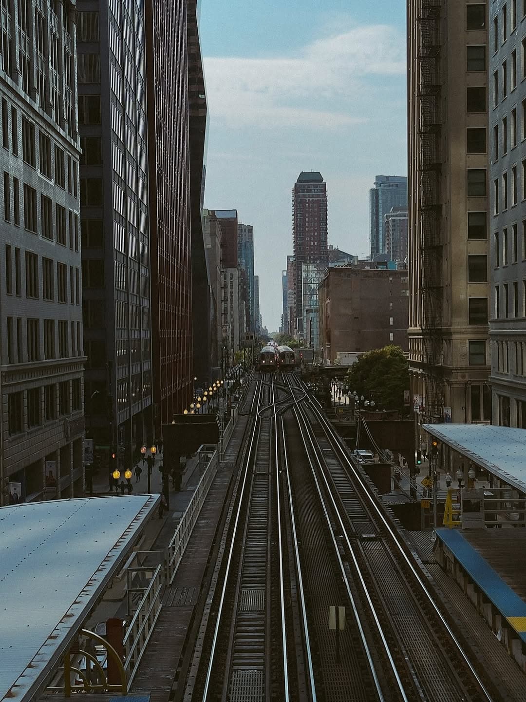 Chicago elevated train tracks stretching into the city skyline