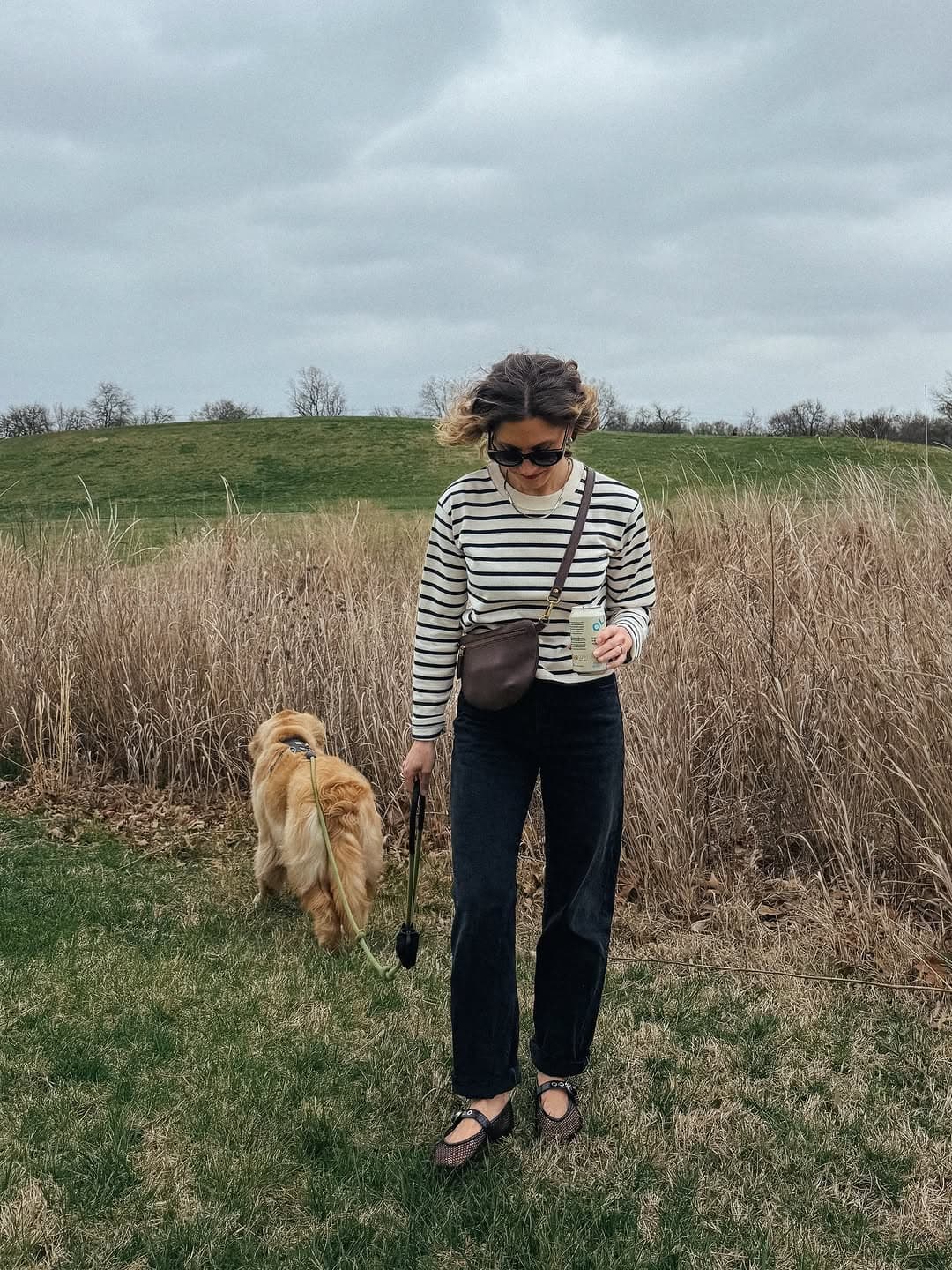 Striped top, dark jeans and Mary Janes on a walk with a golden dog