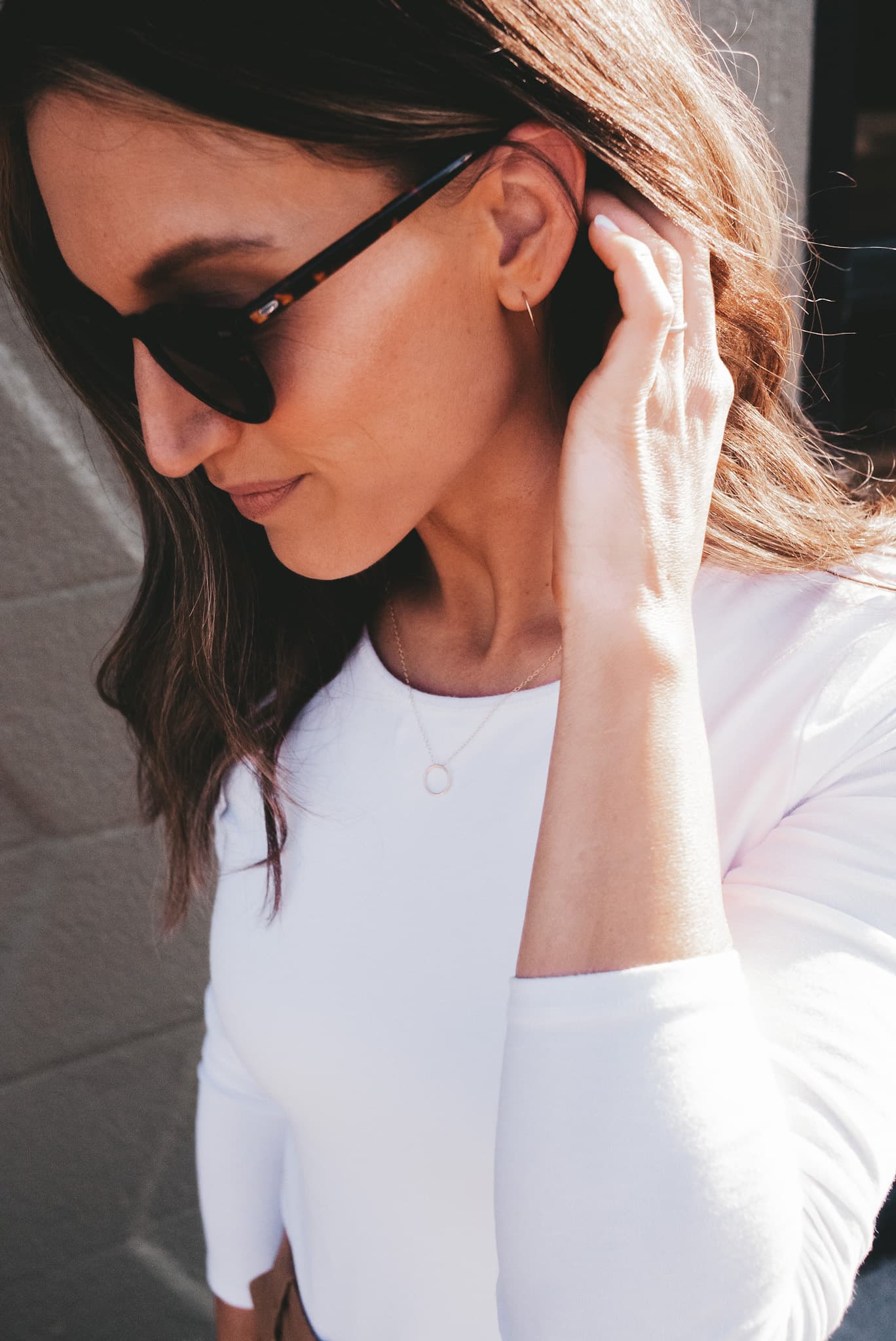 ashley wearing a white bodysuit and sunglasses