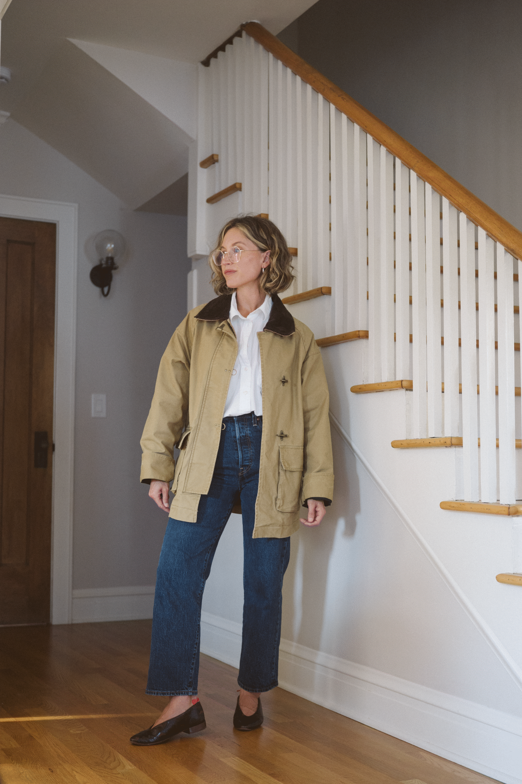 fall outfit with a barn jacket, white button down, dark wash jeans, and python print ballet flats