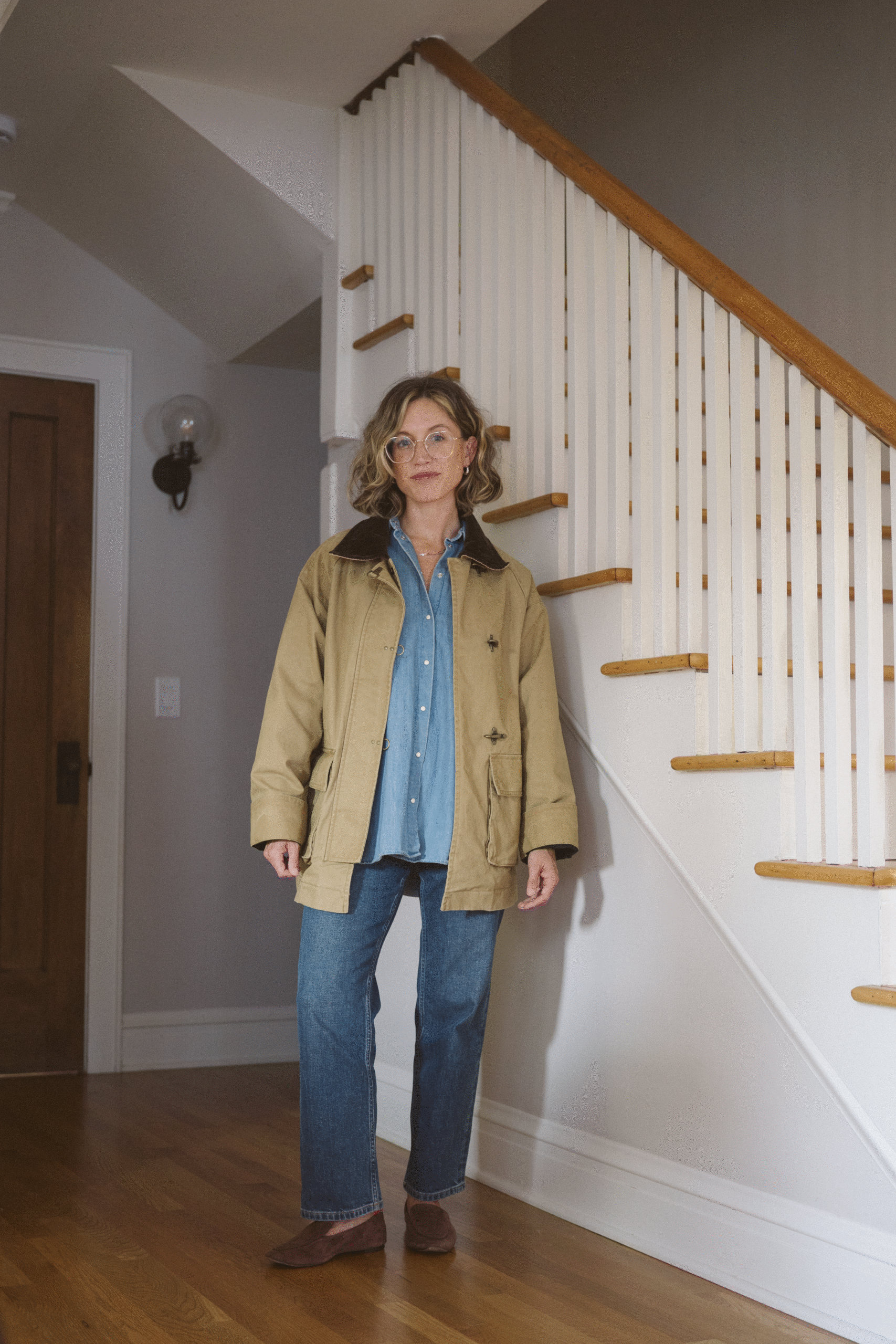 barn jacket outfit with a denim shirt, jeans, and brown suede loafers